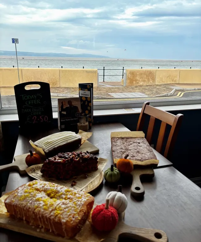 Cake and coffee set beside the waterfront at Tanskeys
